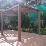 Pergola and deck made with Everwood WPC materials in a garden setting.