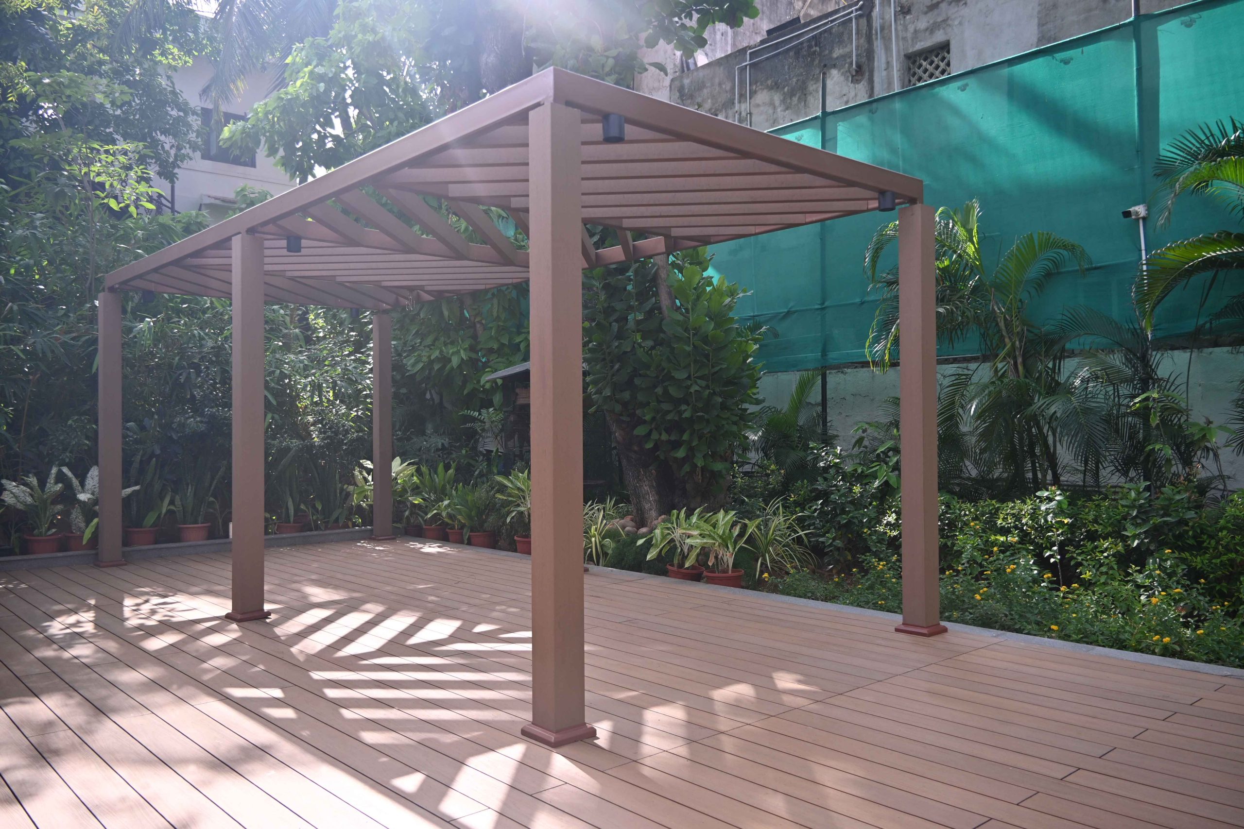 Pergola and deck made with Everwood WPC materials in a garden setting.