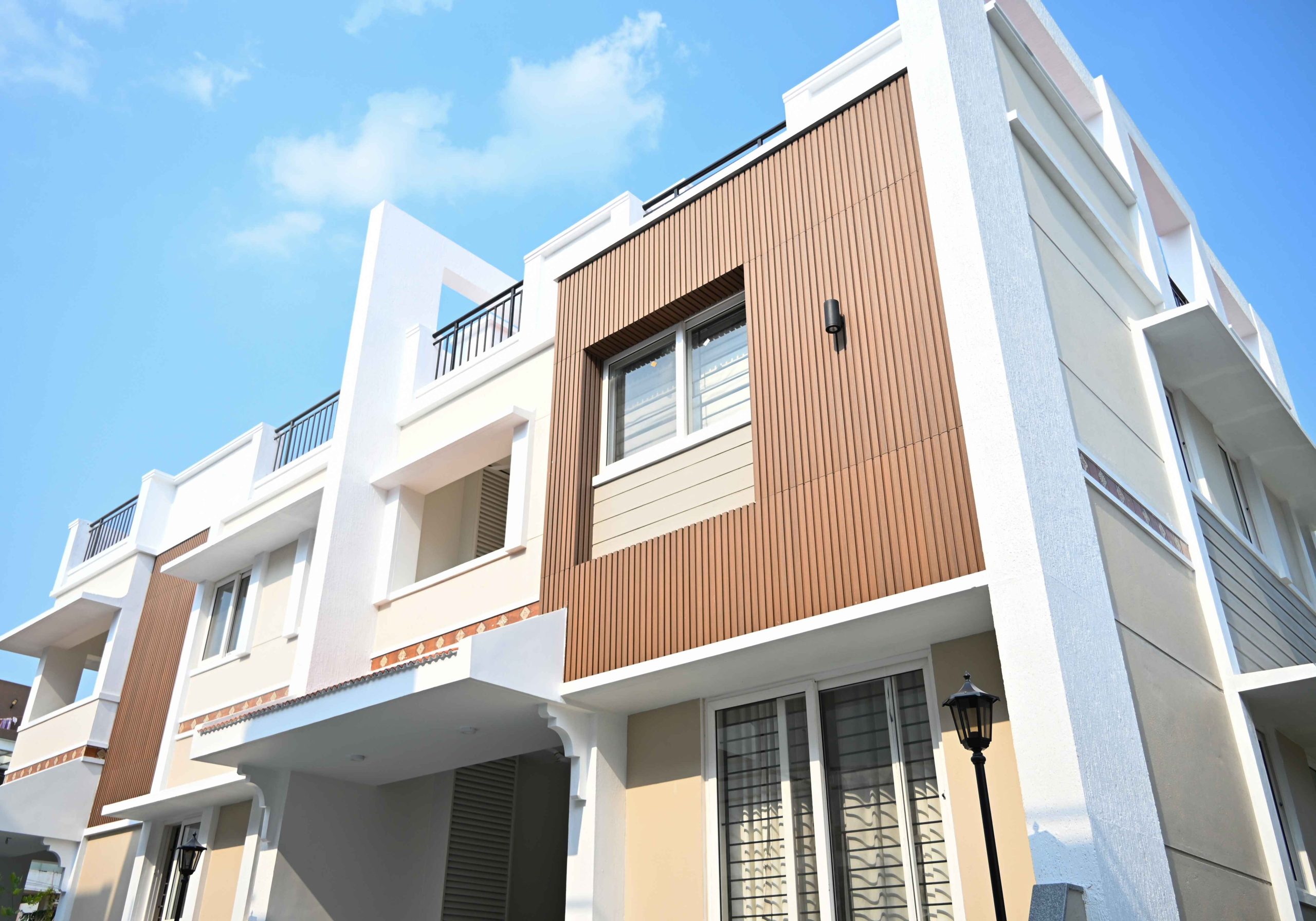Modern building facade with WPC exterior cladding and fluted wall panels.